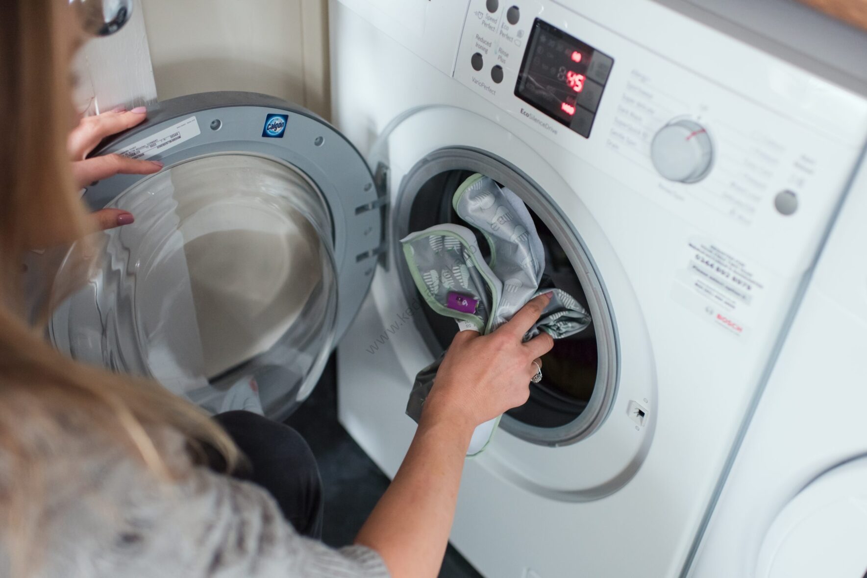 Placing-bib-in-washing-machine-scaled-1.jpg