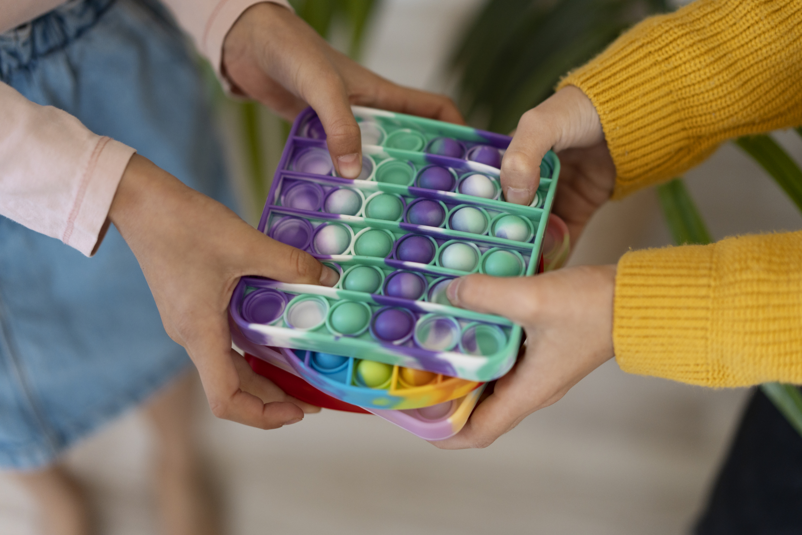 close-up-child-playing-with-pop-it-toy